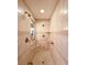 Tiled stand-up shower boasts a rain shower head, shower niche, and grab bars at 1810 Tamerlane Pl, Brandon, FL 33510