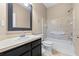 Clean bathroom featuring a vanity with dark wood cabinetry and shower-tub combo with mosaic tile surround at 2020 Greenwood Valley Dr, Plant City, FL 33563