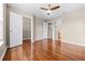 Spacious bedroom with wood floors, ceiling fan, and closet, and neutral walls creating a comfortable space at 2020 Greenwood Valley Dr, Plant City, FL 33563