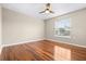 This bedroom has light walls, wood floors, a window and ceiling fan at 2020 Greenwood Valley Dr, Plant City, FL 33563