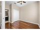 Unstaged bedroom features hardwood floors, neutral paint, and a ceiling fan at 2020 Greenwood Valley Dr, Plant City, FL 33563