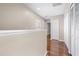 Hallway features sleek wood floors, neutral paint, and natural light, adding warmth and elegance at 2020 Greenwood Valley Dr, Plant City, FL 33563