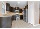 Well-equipped kitchen featuring stainless steel appliances and dark wood cabinetry at 2020 Greenwood Valley Dr, Plant City, FL 33563