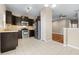 An open kitchen features stainless steel appliances, dark wood cabinetry, and tile flooring at 2020 Greenwood Valley Dr, Plant City, FL 33563