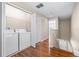 Convenient laundry area with washer, dryer, and shelving for easy organization and storage in hallway at 2020 Greenwood Valley Dr, Plant City, FL 33563