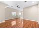 Bright, empty living room with hardwood floors and neutral walls at 2020 Greenwood Valley Dr, Plant City, FL 33563