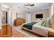 Staged main bedroom with sleek wood floors, modern furniture, and ample natural light, virtually staged at 2020 Greenwood Valley Dr, Plant City, FL 33563