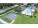 Aerial view of a community pool and basketball court with a clubhouse and parking area at 2020 Greenwood Valley Dr, Plant City, FL 33563