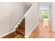 Elegant staircase featuring hardwood steps and flooring at 2020 Greenwood Valley Dr, Plant City, FL 33563
