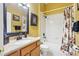 Bathroom with tile flooring, decorative shower curtain, granite countertop, and black hardware at 25950 Risen Star Dr, Wesley Chapel, FL 33544