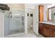Modern bathroom featuring a glass-enclosed shower and granite vanity at 25950 Risen Star Dr, Wesley Chapel, FL 33544