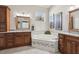 Stylish bathroom with a soaking tub, granite countertops, and wood cabinetry at 25950 Risen Star Dr, Wesley Chapel, FL 33544