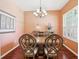 Formal dining room with elegant chandelier, hardwood floors, and classic decor at 25950 Risen Star Dr, Wesley Chapel, FL 33544