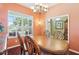Bright dining room with chandelier, a large window, and hardwood floors at 25950 Risen Star Dr, Wesley Chapel, FL 33544