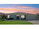 Charming single story home featuring manicured landscaping, covered entry, and a two-car garage at 25950 Risen Star Dr, Wesley Chapel, FL 33544