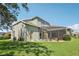 Exterior view of home featuring a screened-in lanai and lush green lawn at 25950 Risen Star Dr, Wesley Chapel, FL 33544