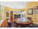 Spacious game room with a poker table, multiple televisions, and dark wood accents at 25950 Risen Star Dr, Wesley Chapel, FL 33544
