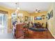 Spacious game room with a wet bar, poker table, and multiple televisions for entertaining guests at 25950 Risen Star Dr, Wesley Chapel, FL 33544