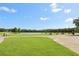 Picturesque golf course with a lake, manicured green grass and various players enjoying a sunny day at 25950 Risen Star Dr, Wesley Chapel, FL 33544