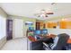 A home office with carpet, three monitors, a ceiling fan, and natural lighting at 25950 Risen Star Dr, Wesley Chapel, FL 33544