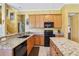 Open kitchen featuring granite countertops, stainless steel appliances, and a breakfast bar at 25950 Risen Star Dr, Wesley Chapel, FL 33544