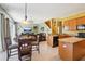 Open-concept kitchen featuring a dining area, breakfast bar and views of the Gathering room at 25950 Risen Star Dr, Wesley Chapel, FL 33544