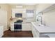 Well-lit kitchen with white cabinetry, stainless steel range, and quartz countertops at 25950 Risen Star Dr, Wesley Chapel, FL 33544