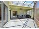 Spacious covered lanai with a ceiling fan, outdoor furniture, and a grill at 25950 Risen Star Dr, Wesley Chapel, FL 33544