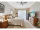 Cozy main bedroom featuring plush carpeting, a ceiling fan, and ample natural light at 25950 Risen Star Dr, Wesley Chapel, FL 33544