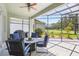Covered patio with outdoor seating, overlooking the lush green landscape and golf course at 25950 Risen Star Dr, Wesley Chapel, FL 33544