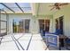 Relaxing covered patio with outdoor seating and view of lush landscaping and golf course at 25950 Risen Star Dr, Wesley Chapel, FL 33544