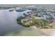 Stunning aerial view of condo buildings along the water, surrounded by lush greenery and a picturesque beach at 2700 Bayshore Blvd # 6210, Dunedin, FL 34698