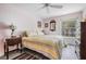 Bright bedroom with a ceiling fan features a serene view and a restful striped bed at 2700 Bayshore Blvd # 6210, Dunedin, FL 34698