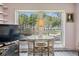 Bright living space features a window offering serene nature views and a small breakfast table at 2700 Bayshore Blvd # 6210, Dunedin, FL 34698
