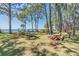 Community park with picnic tables, benches, swings and waterfront access surrounded by shady trees at 2700 Bayshore Blvd # 6210, Dunedin, FL 34698