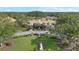 Aerial view of the community clubhouse surrounded by lush landscaping and well-manicured lawns at 2850 Doone Cir, Palm Harbor, FL 34684