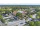 Overhead view of the community clubhouse featuring shuffleboard courts, pool, and ample parking at 2850 Doone Cir, Palm Harbor, FL 34684