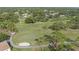Aerial view showcasing a meticulously maintained golf course with lush green fairways and mature trees at 2850 Doone Cir, Palm Harbor, FL 34684