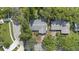 Aerial view of the house showing the roof and mature landscaping surrounding the property at 2850 Doone Cir, Palm Harbor, FL 34684