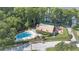 Aerial view of community center with a refreshing pool, surrounded by lush greenery and seating areas at 2850 Doone Cir, Palm Harbor, FL 34684