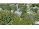 Aerial view of home surrounded by lush trees in a quiet, residential neighborhood at 2850 Doone Cir, Palm Harbor, FL 34684