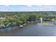 Stunning aerial view showcasing the lake, lush greenery, and docks along the shore at 2850 Doone Cir, Palm Harbor, FL 34684