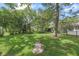 Large backyard with mature trees and lush green lawn, perfect for outdoor activities at 2850 Doone Cir, Palm Harbor, FL 34684