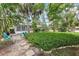Beautiful backyard with tropical landscaping, patio area, and comfortable outdoor seating at 2850 Doone Cir, Palm Harbor, FL 34684