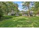 Expansive backyard with well-maintained lawn and mature trees, offering a serene outdoor space at 2850 Doone Cir, Palm Harbor, FL 34684
