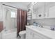 Clean bathroom featuring a vanity and storage and a tub with shower at 2850 Doone Cir, Palm Harbor, FL 34684