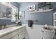 Bright bathroom with a vanity, decorative mirrors, and white wainscoting at 2850 Doone Cir, Palm Harbor, FL 34684