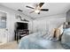 Cozy bedroom featuring a ceiling fan, neutral walls, and plenty of closet space at 2850 Doone Cir, Palm Harbor, FL 34684