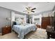 Bedroom with neutral walls, ceiling fan, plush carpet, and sun-filled windows at 2850 Doone Cir, Palm Harbor, FL 34684