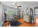 Charming dining room with wood-style floors, stylish table, and a view to kitchen at 2850 Doone Cir, Palm Harbor, FL 34684